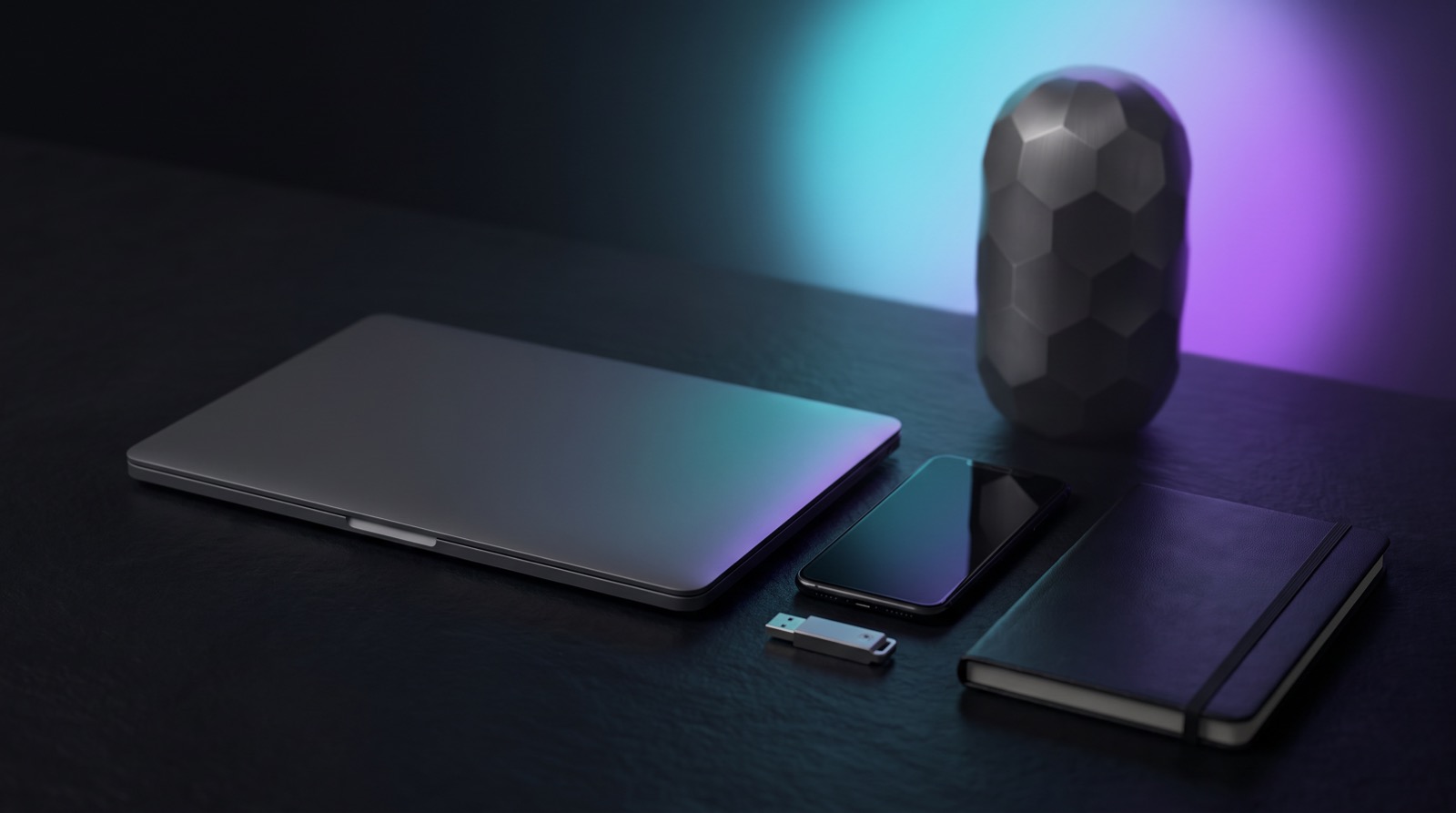 A closed laptop, a switched-off phone, a USB drive and a notebook neatly arranged on a table, with the Inheritans capsule in the background